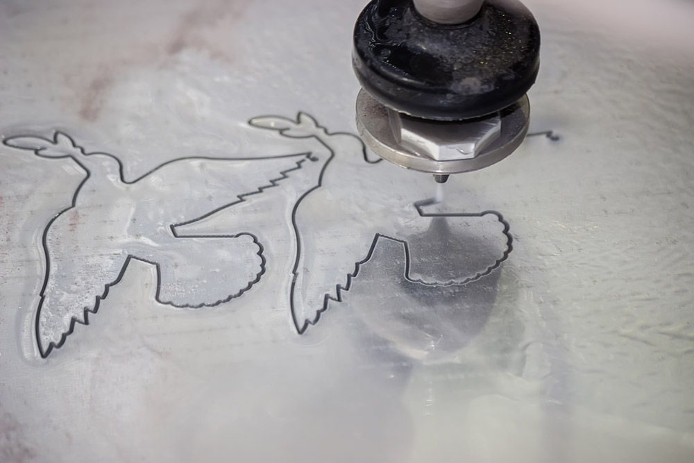 doves cut into steel by waterjet machine