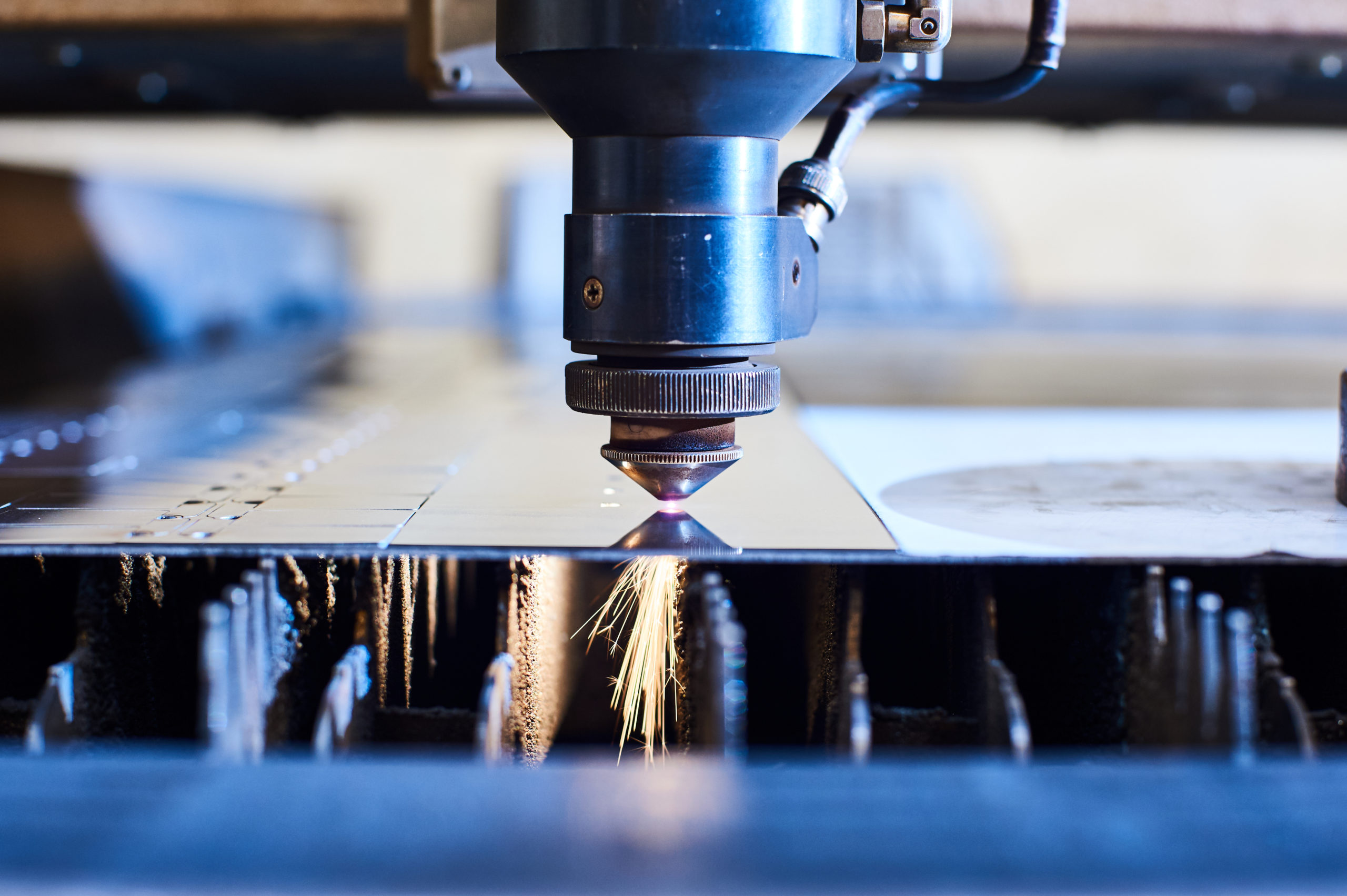 CNC laser cutting machine making intricate cuts through steel.
