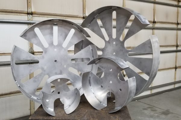 Rolled aluminum coiler pans cut on a waterjet and welded.