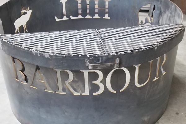 Custom text and elk insignia cut onto a firepit using a waterjet.
